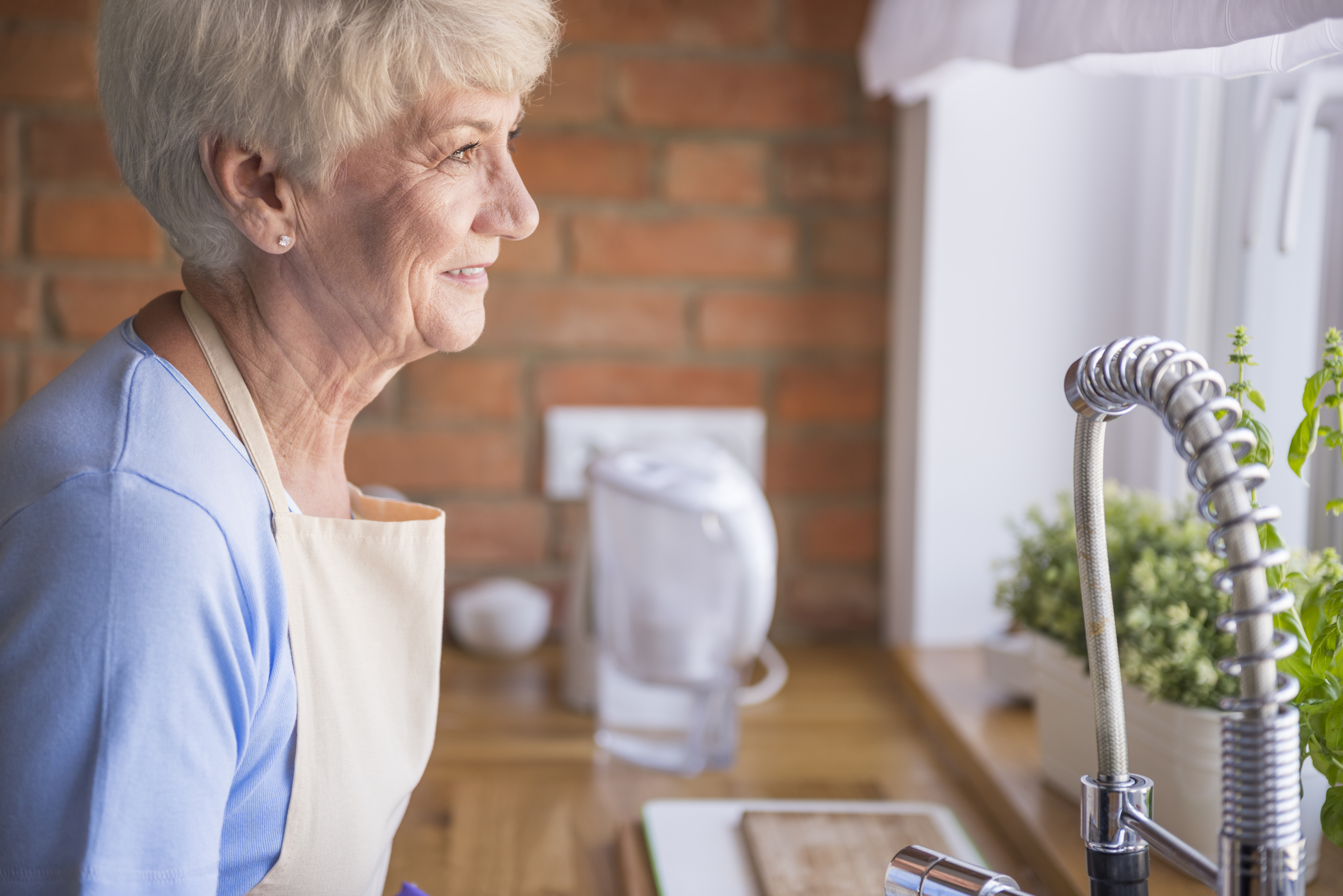 senior-woman-looking-through-kitchen-window.jpg